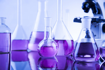 Laboratory work place with microscope and glassware