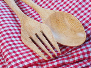 Wooden kitchen spoon on a red and white napkin