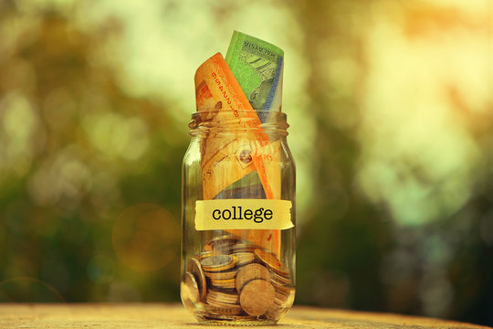 Saving Money Concept With College Text Written On Glass Jar.Selective Focus And Shallow Depth Of Field.
