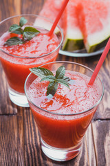 Watermelon smoothie on a wooden table.