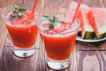 Watermelon smoothie on a wooden table.