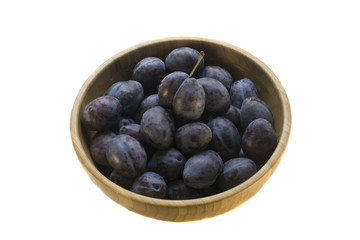 sweet juicy purple plums in a bamboo plate
