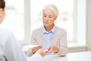 doctor giving prescription and drug to woman 