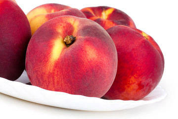 Peaches on white plate
