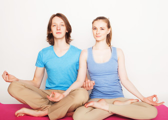 Fototapeta na wymiar Young couple in yoga pose
