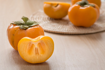 Fresh Persimmon fruit on wood table.