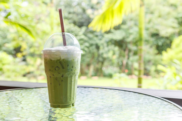 Ice green tea latte on table in cafe