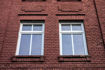 Windows in a red wall