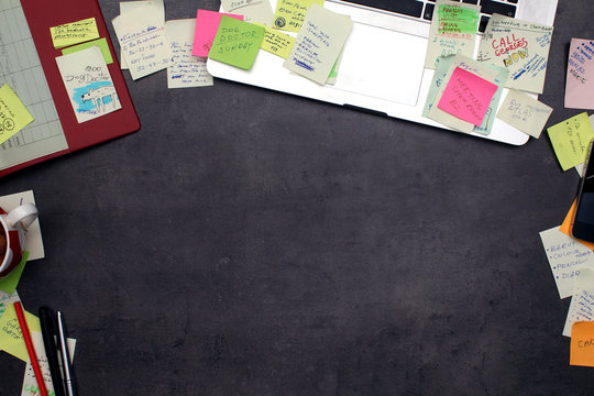 Office workspace covered by post it papers