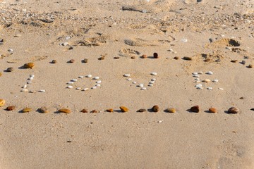 The word love written at the beach