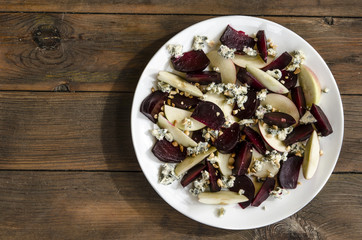 Apple salad with beetroot and walnuts blue cheese dressed with balsamic vinegar   