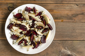 Apple salad with beetroot and walnuts blue cheese dressed with balsamic vinegar   
