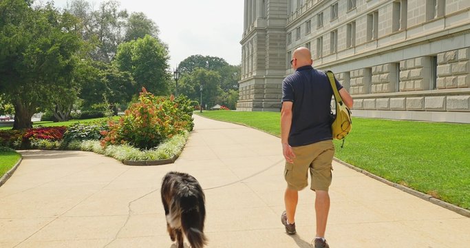 Man Walks Dog Near the Library of Congress in Washington DC