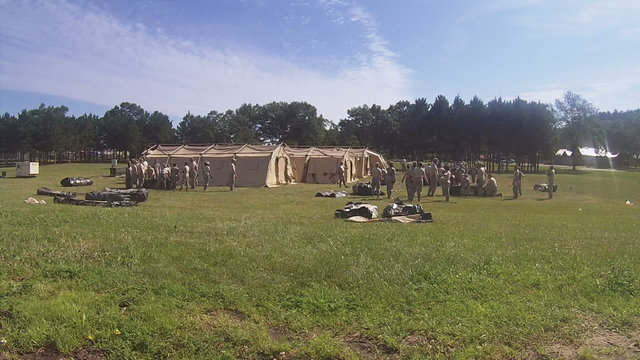 A group of soldiers set up a military mobile hospital camp.
