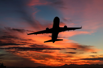 Fototapeta na wymiar Airplane on sunrise with beautiful sky at twilight time