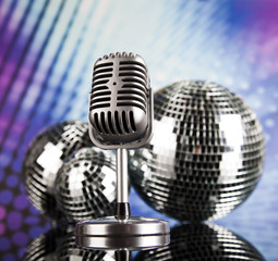 Fototapeta na wymiar Retro style microphone on sound waves and Disco Balls 