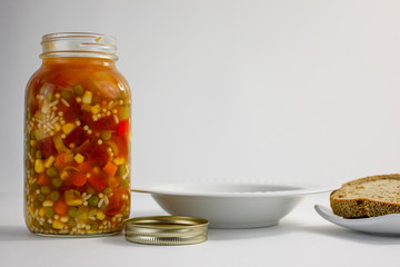 jar of vegetable soup on a white background 