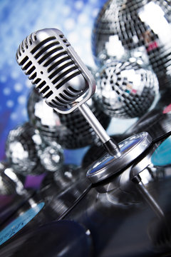 Retro style microphone on sound waves and Disco Balls 