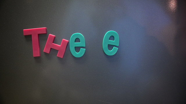 Forming the phrase "The End" in colorful refrigerator magnets.