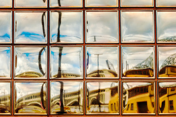 Glass block art - industrial section of Cleveland, Ohio, reflected in window