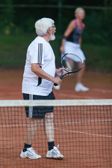 Senior man playing tennis