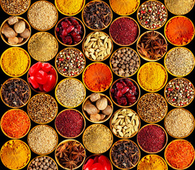 Different spices on black background