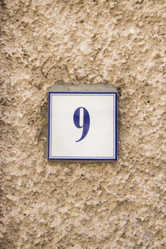 Number nine on the stome wall