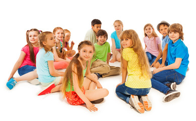 Large group of kids sit together in circle