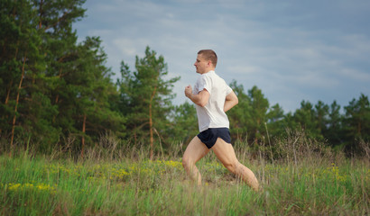 Young man jogging outdoors.