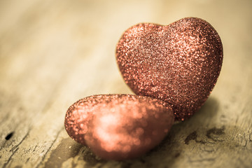 Obraz premium Valentine day background. Red two hearts on grunge wood table. Retro filter