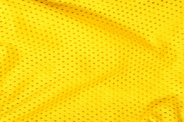 Yellow textile pattern as a background. Close up on yellow crumpled material with holes texture on...