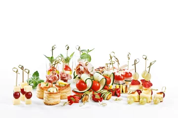 Tuinposter great attractive set of canapes with vegetables, cheese, fruits, berries, salami, seafood, meat and decoration on white background studio isolated with space for text template © Maksim Denisenko