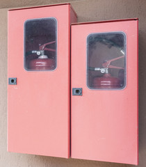 Two fire extinguishers in their lockers