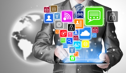 Business man using tablet PC with social media icon set