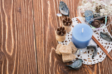 spa stuff on wooden background: candle, aroma