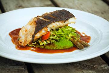 Fish dish - fish fillet in sauce and vegetables..,