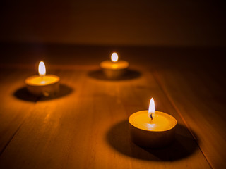 candle in meditation placed on wooden floor