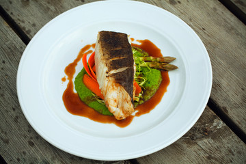 Fish dish - fish fillet in sauce and vegetables..