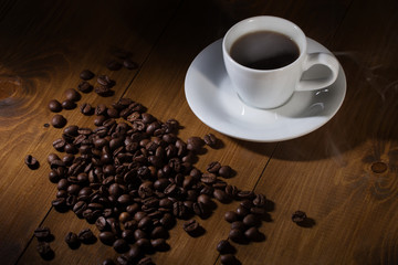 coffee cup and beans on wooden table 