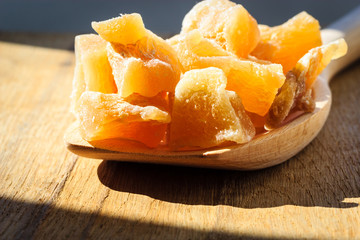 Closeup candied ginger on wooden spoon