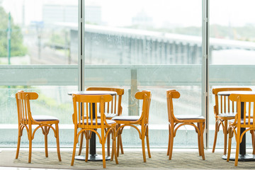 Empty chair and table in restaurant near the window.