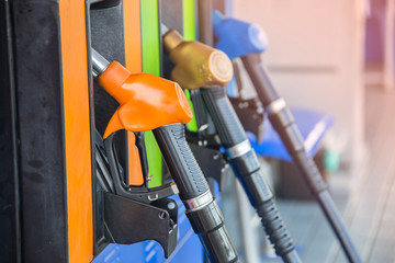 Gas pump nozzles in a service station
