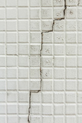 Cracked of old white tile wall