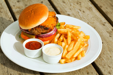 Delicious burger on wooden board.