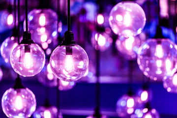 Fototapeta na wymiar Beautiful retro luxury light lamp decor glowing with purple filter.
