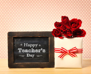 Happy Teachers Day message with gift box and red roses