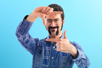 Vintage young man focusing with his fingers