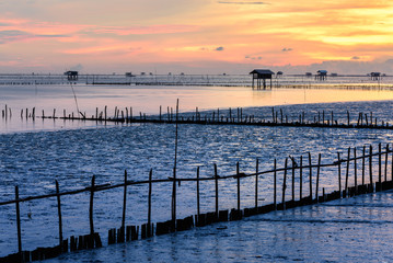 Silhouette of bamboo cottage with morning sunshine in gulf of Thailand.