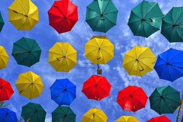 Fototapeta na wymiar Lots of umbrellas coloring the sky.
