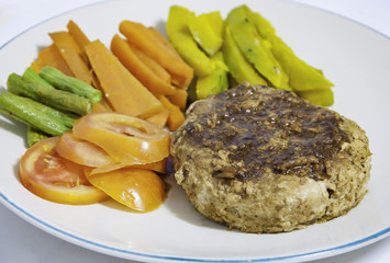 Pork Steak with vegetables on a white plate